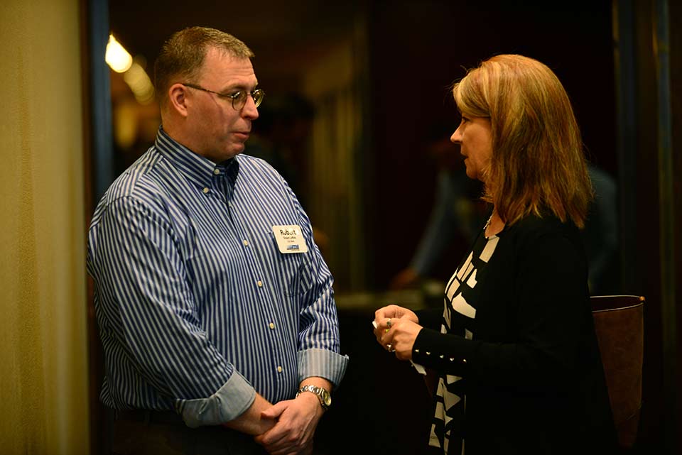 Woman talking to man at an event