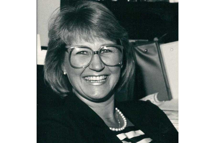 A smiling woman wearing glasses