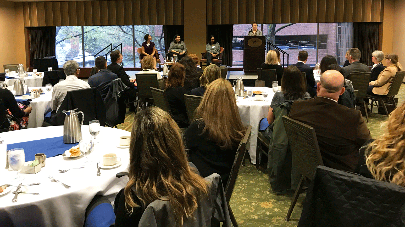 Woman addressing to people in a conference room