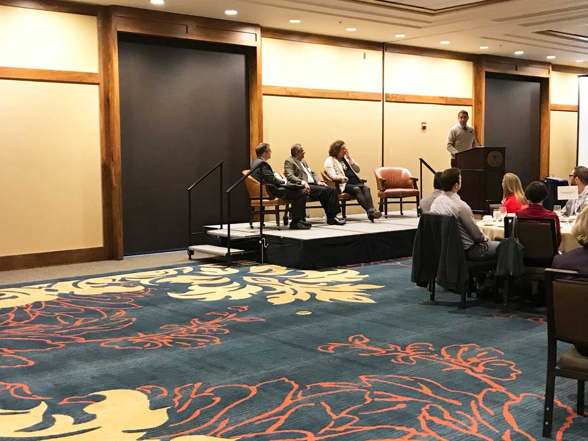 A guy addressing to people in the conference room