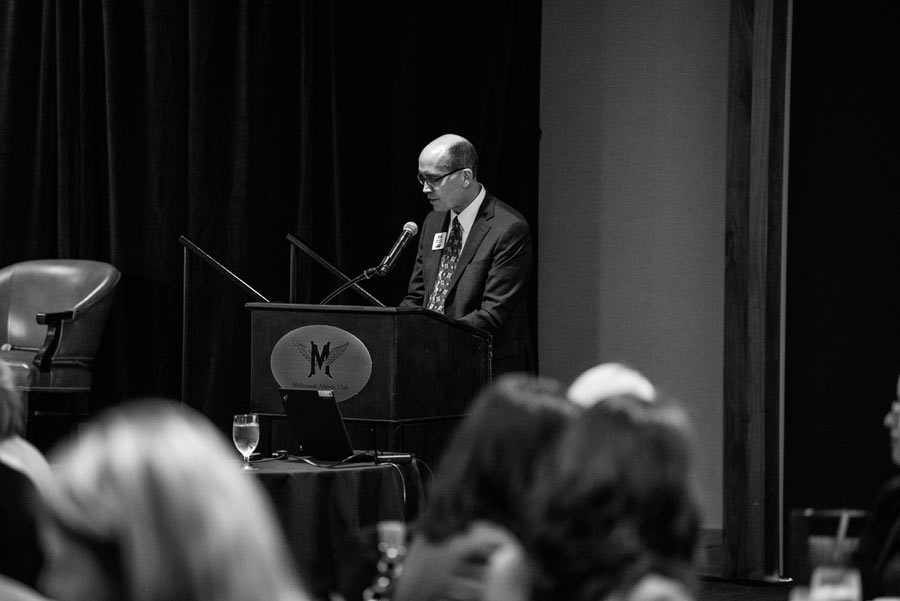 Man standing on stage giving speech