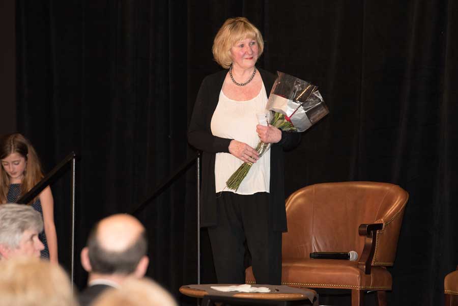 An old lady with a bouquet in her hand