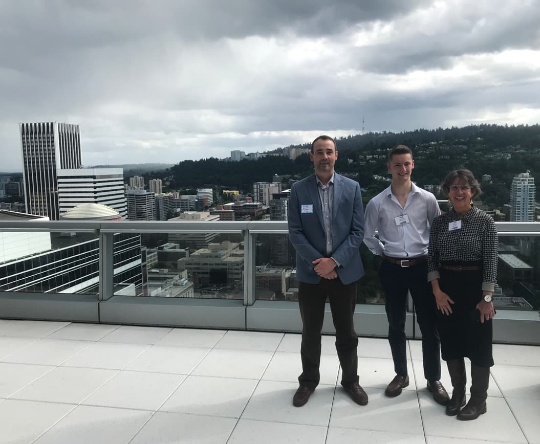 Men and woman standing on the rooftop