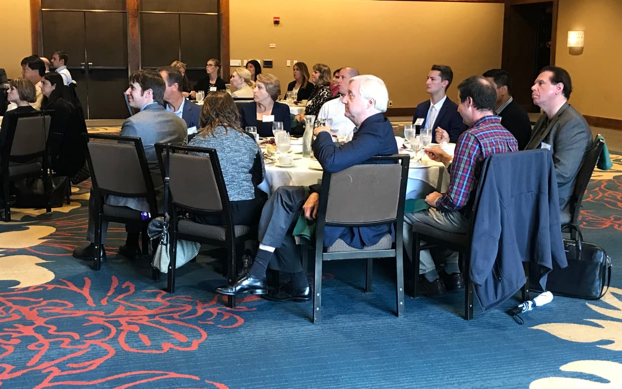 People listening to speaker in the room