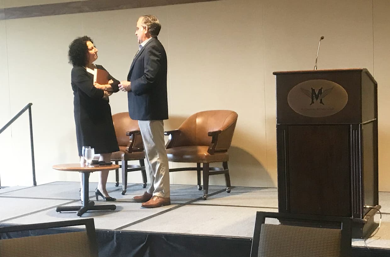 Man and woman having conversation on a stage